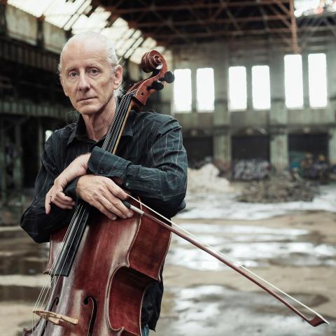 A photo of Fried Dähn holding a cello