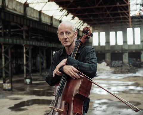 A photo of Fried Dähn holding a cello